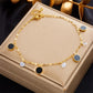 Seraphina Double-Layer Gold-Tone Charm Anklet – Heart, Butterfly, Shell & Pearl Details